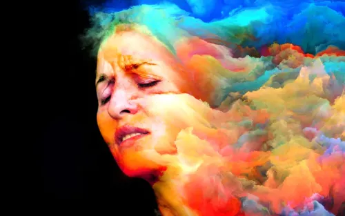 Shape of a face emerging from a rainbow palette of clouds.