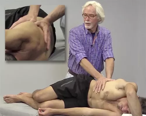 Close-up views of Erik Dalton's palms and hands as he works on a sidelying client's lateral fascia.