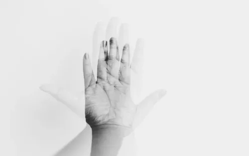A palm of a hand held up to gesture stop.