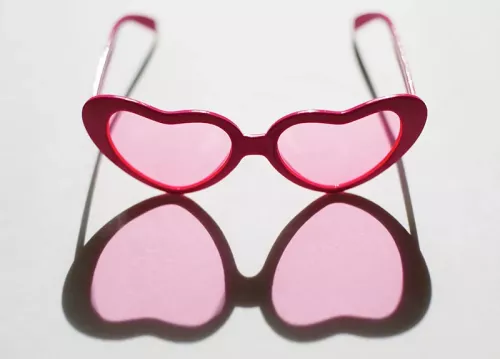 a pair of rosy pink heart shaped sunglasses.