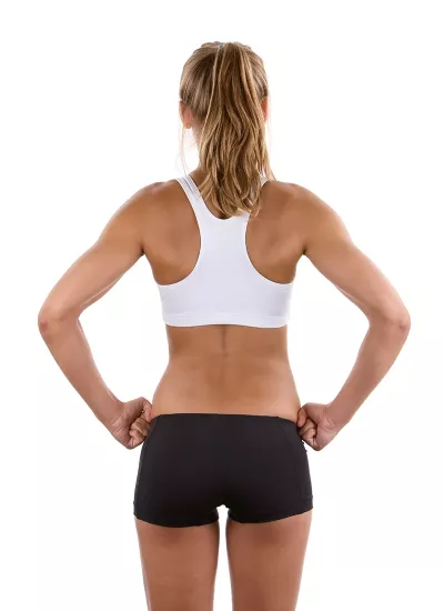 A woman's back with her hands on her hips.