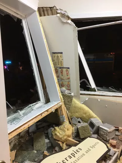 Exterior and interior window and wall damage at a place of business. The massage room is destroyed.