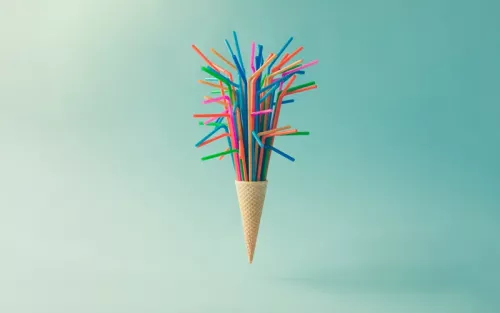 A cup filled with dozens of colorful straws.