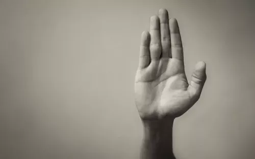 A hand held up to signal stop.
