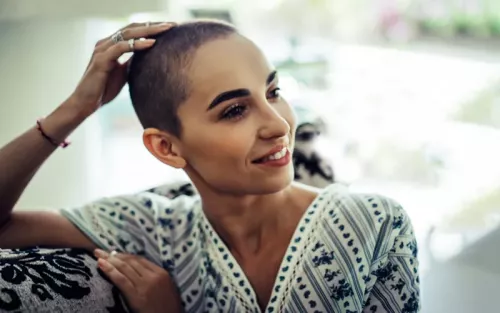 A woman with a short buzzed haircut.