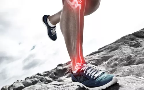 A runner lower leg and ankle bones highlighted in red to show pain and inflammation.
