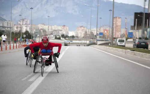 A paracyclists speeds forward during a road race.