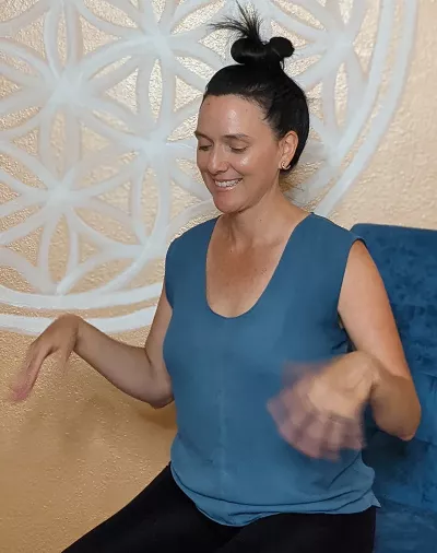 Nicole Reed bent at the elbows, shaking out both hands.