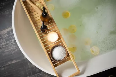 a bathtub with salts, aromatics, a scrub brush, and bubbles.
