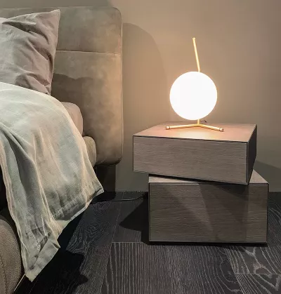 tranquil room with a bed and globe-shaped floating lamp giving off soft light.