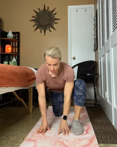 Author Marisa Savino puts one leg forward in a crunched modified lunge, known as lizard or runners stretch.