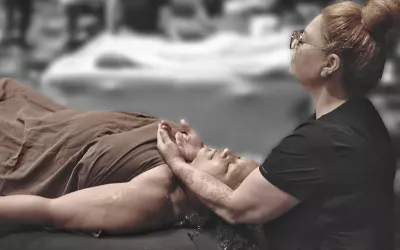 Picture of Jessica Irelan performing massage on a clients shoulders and neck.