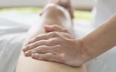 A massage therapists tends to a client's leg.